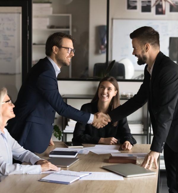 Two,Happy,Confident,Business,Partners,Men,Shaking,Hands,Over,Large